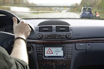 Mercedes-Benz E-Class Saloon, 211 series, test vehicle 2006. The mobile radio-based information exchange made it possible to report hazards once detected, for example a broken-down vehicle on the side of the road or heavy rain, to other vehicles and road users and give them a timely warning.